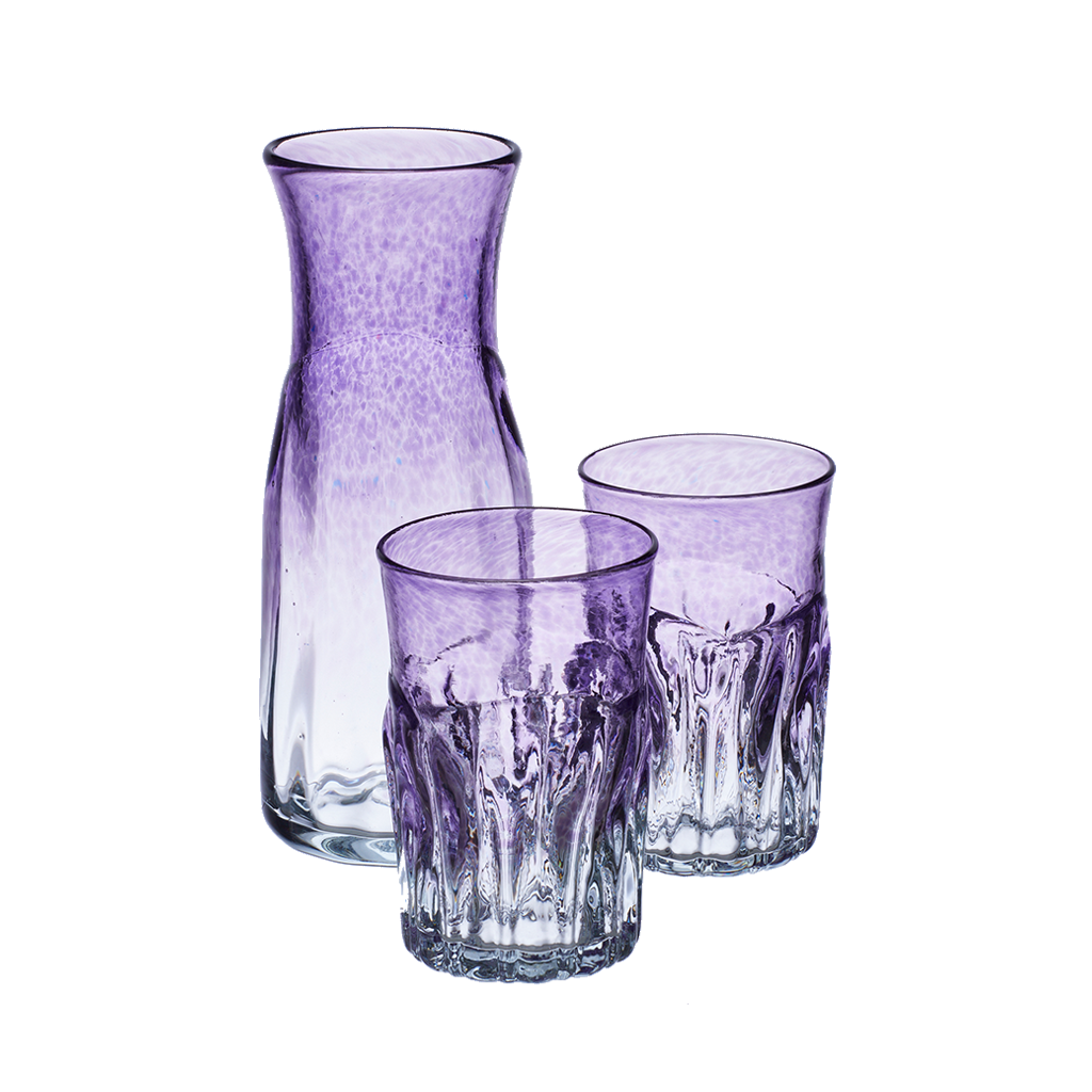 Carafe and two glasses with clear glass on the bottom and purple glass on the top. On a transparent background.