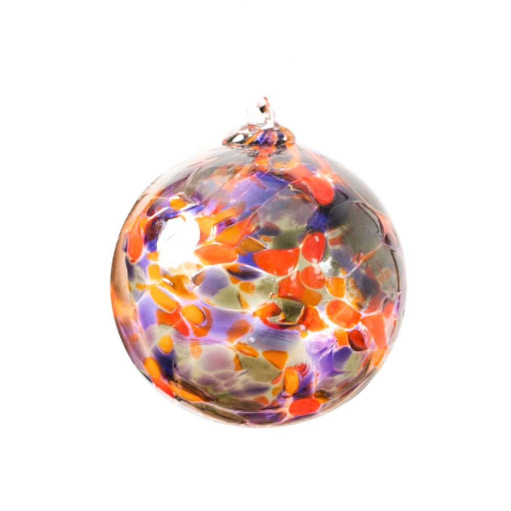 Round glass ball with purple, orange and grey glass mosaiced around the entire surface on a transparent background.