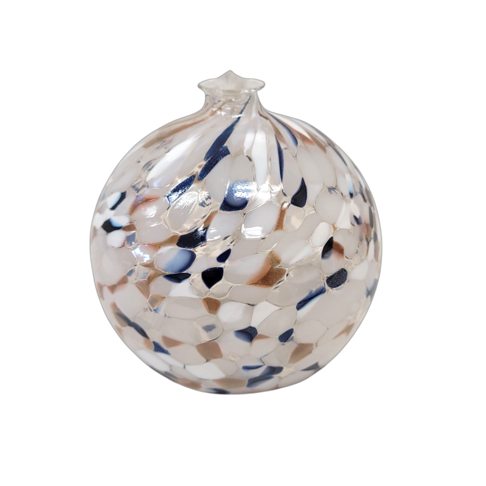 Round glass ball with flat base and wick with opaque navy glitter, opaque copper glitter and opaque white glass mosaiced around the entire surface on a transparent background.