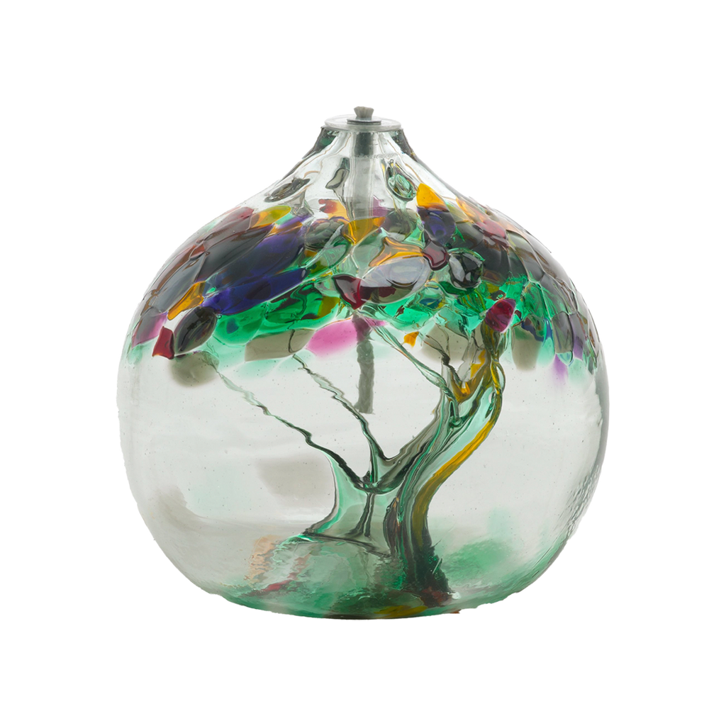 Clear glass flat bottom orb with green glass pulled through the middle and yellow, red, purple, pink, grey, and green bits on top on a transparent background. on a transparent background.