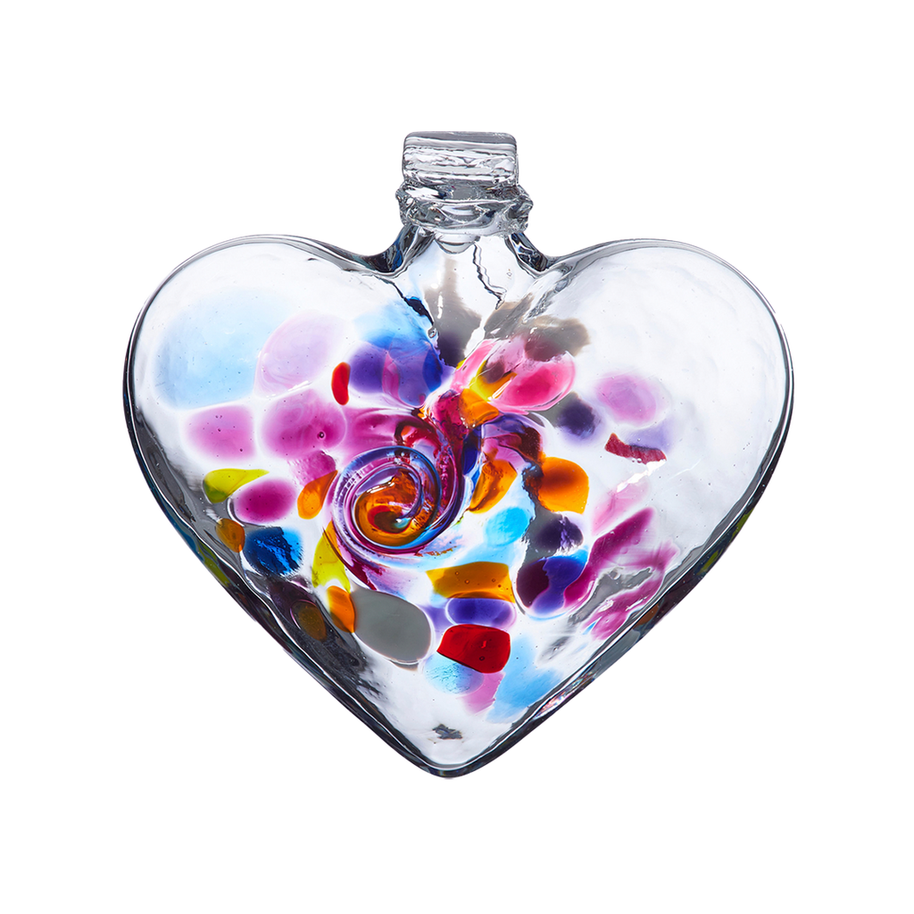 Clear glass heart with blue, yellow, purple, pink, orange and opaque white glass swirled in the centre on a transparent background.