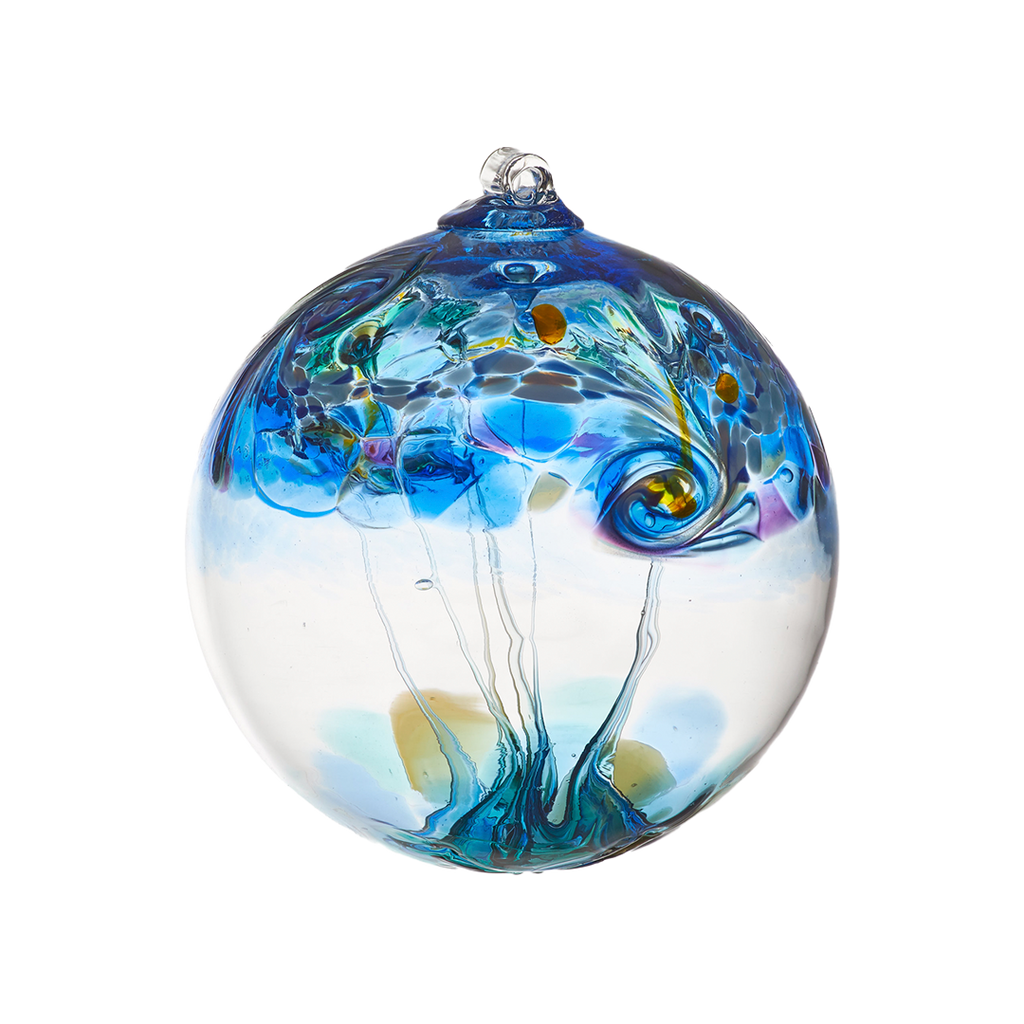 A clear glass orb with blue, red, green, yellow, opaque white, orange and purple swirled on the top half with clear webbing pulled from bottom to top on a transparent background