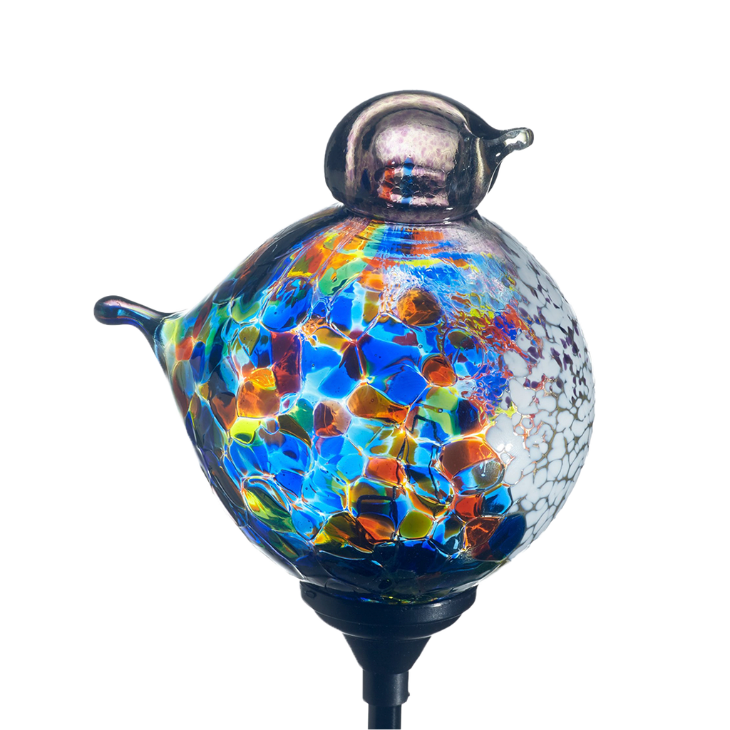 Glass bird with blue, orange, lime mosaic along the surface, with a purple head and opaque white on chest with a black clip on a transparent background.