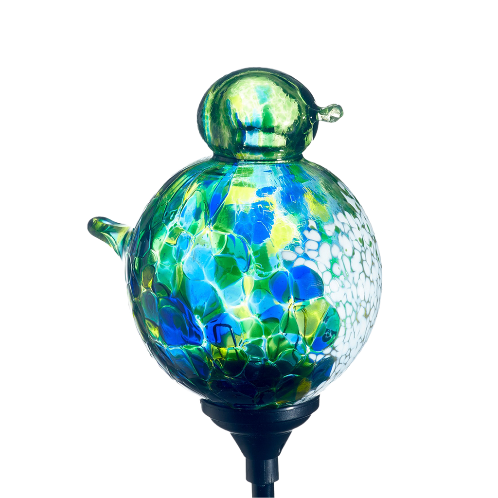 Glass bird with blue, green and lime mosaic along the surface and opaque white on chest with a black clip on a transparent background.