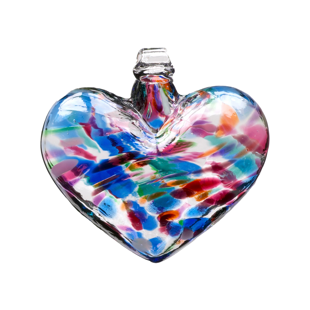 Glass heart with blue, opaque white, pink, orange and green mosaiced around the entire surface on a transparent background.