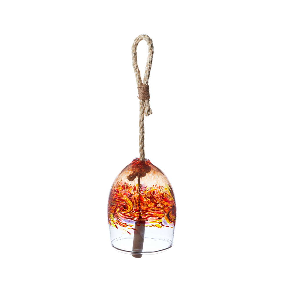 A clear glass bell with red, orange, yellow and purple glass swirled across the middle. A wooden toggle and rope are pulled through the middle. Displayed on a transparent background.