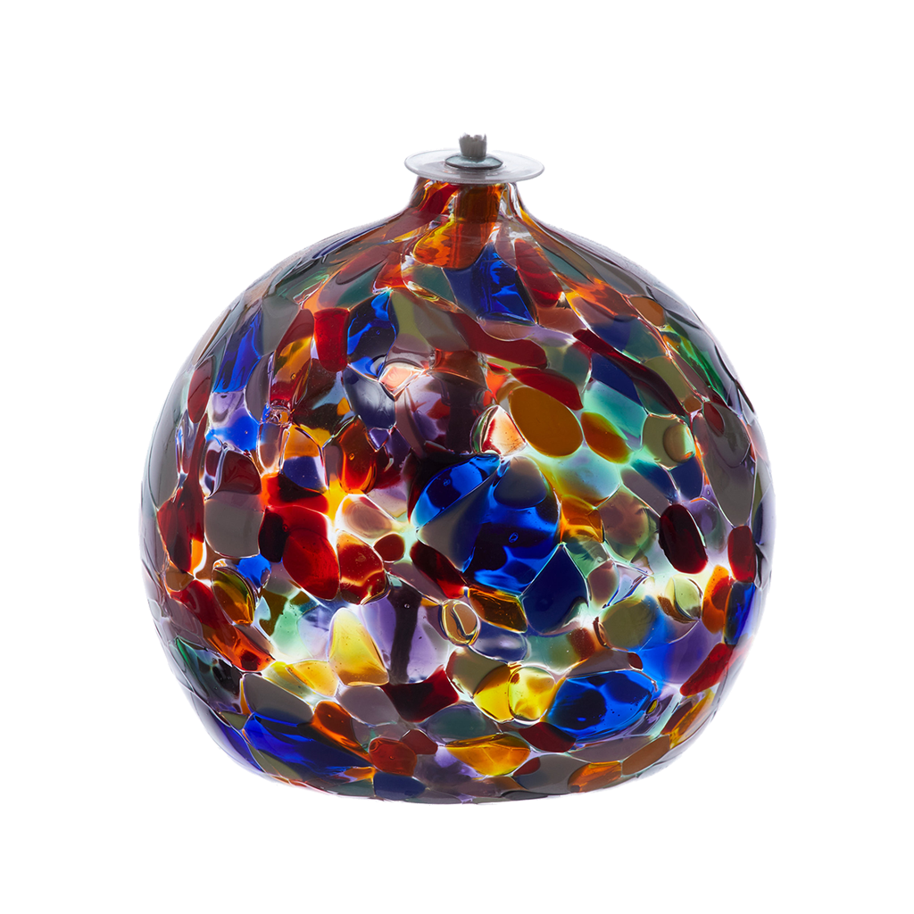 Round glass ball with flat base and wick opaque pink, blue, yellow, purple, opaque green, opaque yellow, lime and opaque white glass mosaiced around the entire surface on a transparent background.
