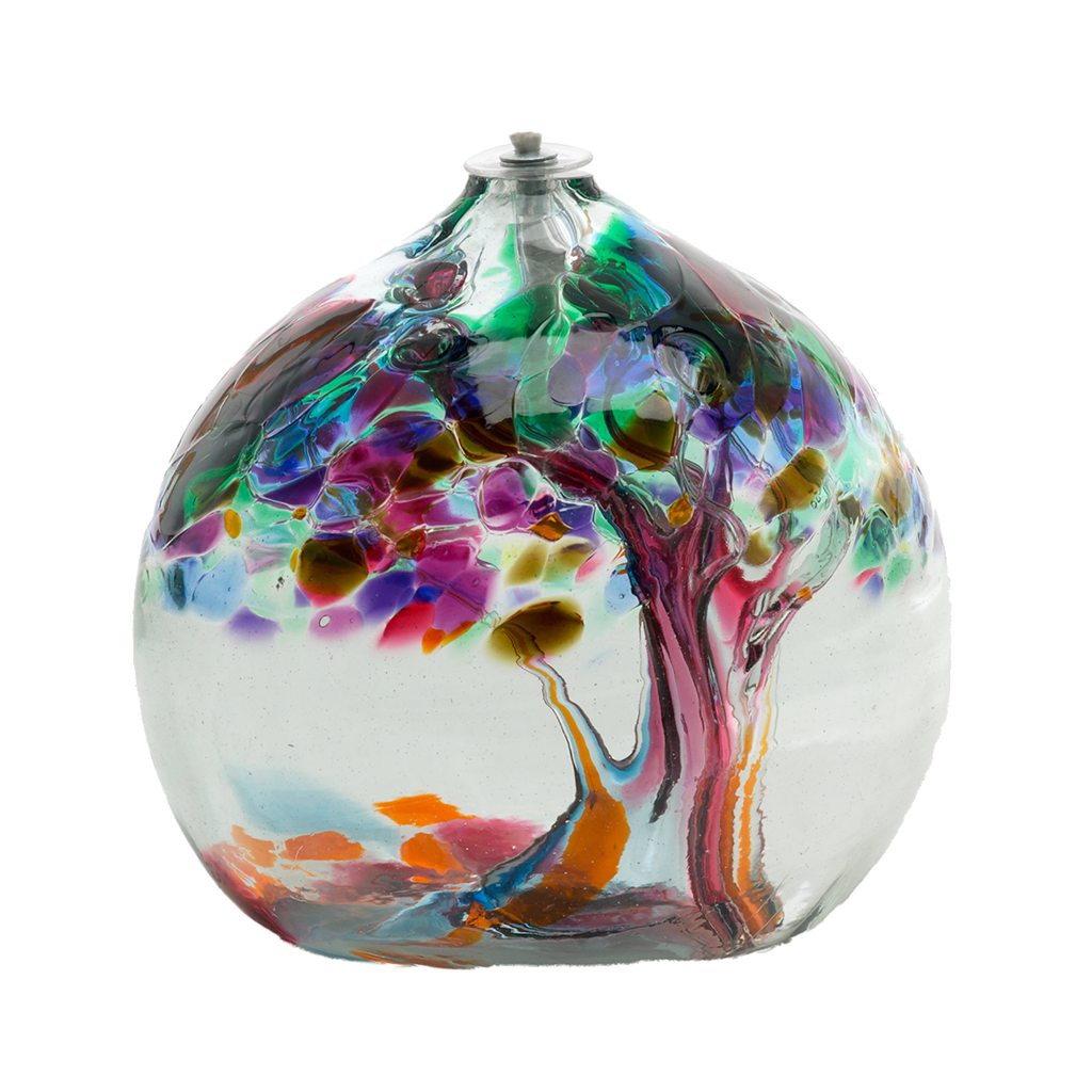 Clear glass flat bottom orb with orange, pink and green glass pulled through the middle and purple, pink, orange, green, blue and amber bits on top on a transparent background.
