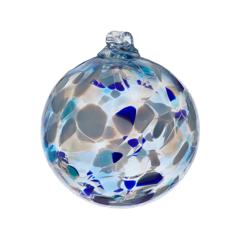 Round glass ball with white, dark blue and light blue glass mosaiced around the entire surface on a transparent background. 