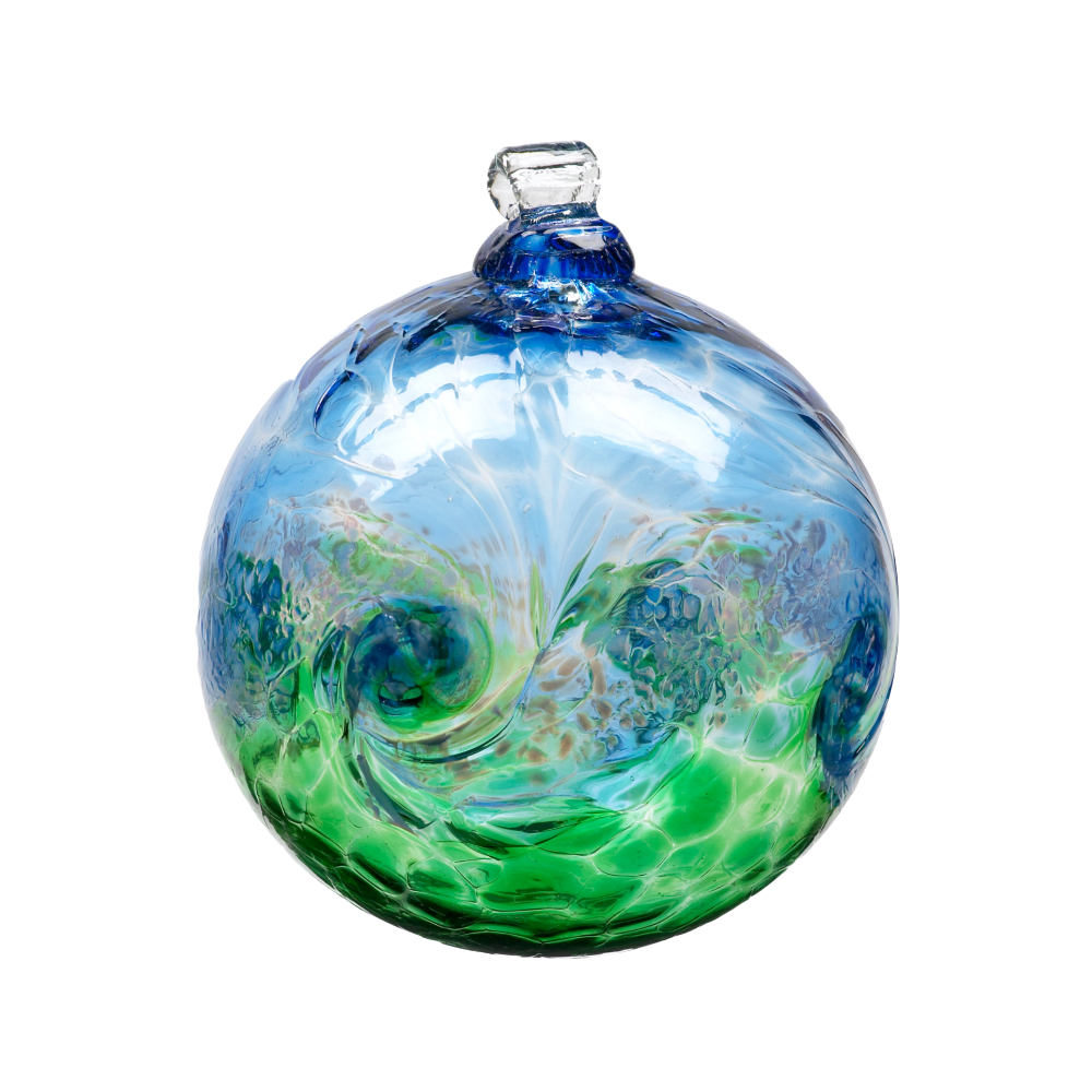 Glass orb with blue on top, white swirled across the middle, and green on the bottom on a transparent background. 