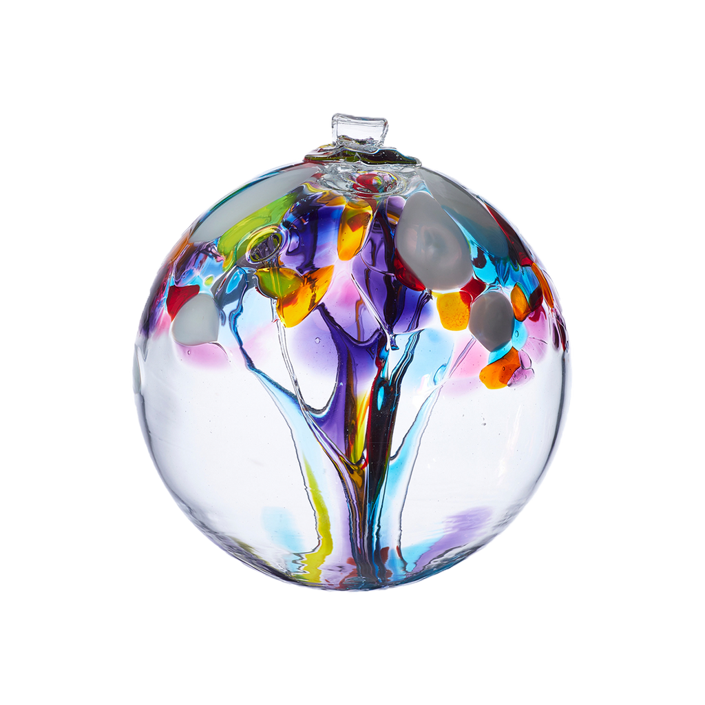 Clear glass orb with purple, orange, yellow and blue glass pulled through the middle and yellow, white, red, purple, pink, orange and blue bits on top on a transparent background.