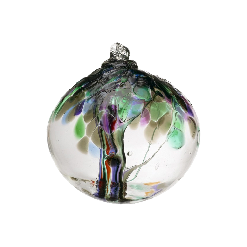 Clear glass orb with grey, purple, green and red glass pulled through the middle and red, purple, grey, green and blue bits on top on a transparent background.