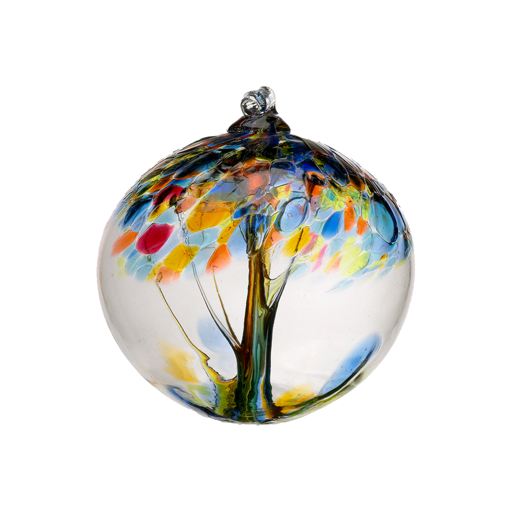 Clear glass orb with blue and orange glass pulled through the middle and yellow, red, orange and blue bits on top on a transparent background.