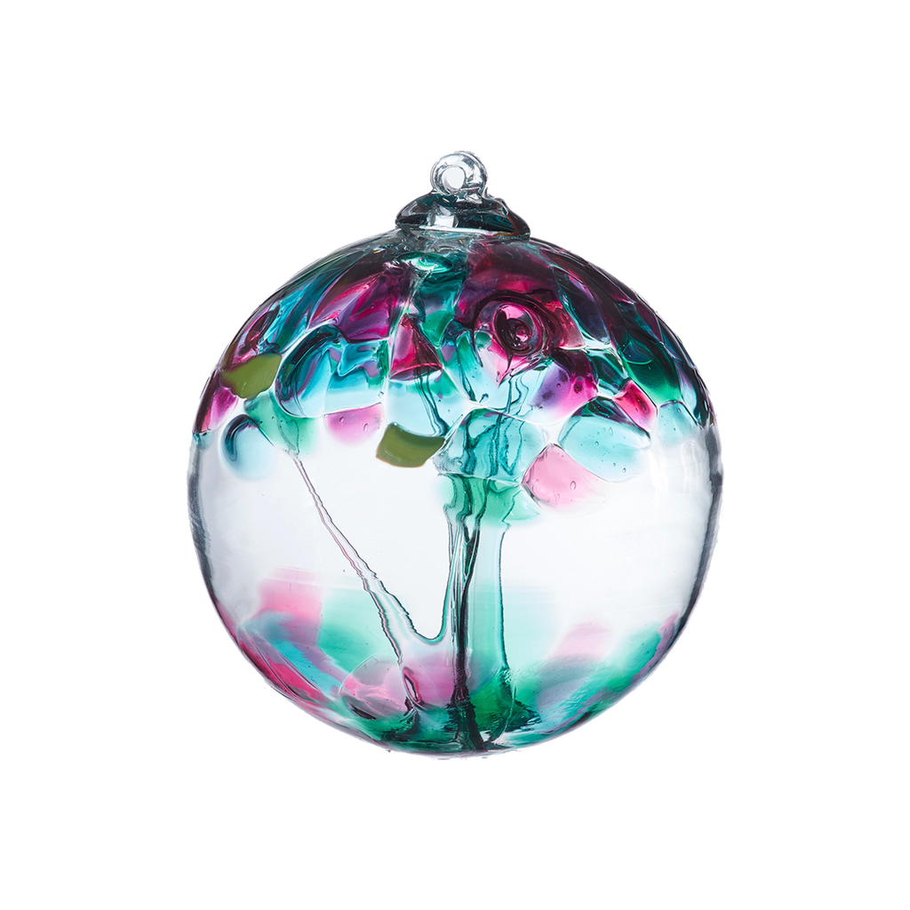 Clear glass orb with teal glass pulled through the middle and teal, purple, pink, green and blue bits on top on a transparent background.