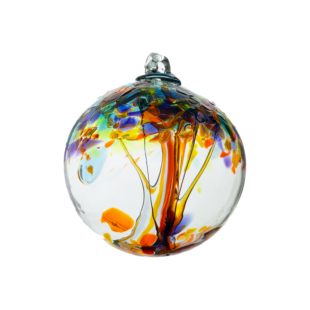Clear glass orb with orange glass pulled through the middle and yellow, red, purple, orange, green and blue bits on top on a transparent background.