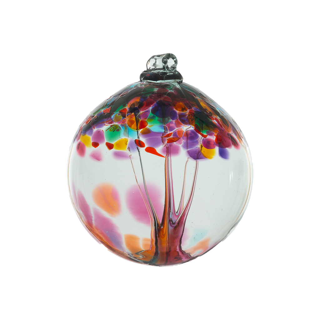 Clear glass orb with pink and orange glass pulled through the middle and yellow, red, purple, pink, orange, green and blue bits on top on a transparent background.