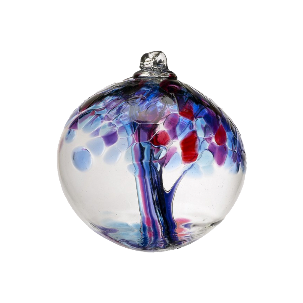 Clear glass orb with amethyst and purple glass pulled through the middle and Blue, Dark Blue, Amethyst, Purple and Red bits on top on a transparent background.