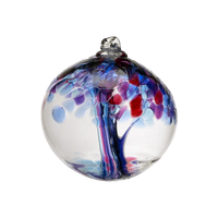 Clear glass orb with amethyst and purple glass pulled through the middle and Blue, Dark Blue, Amethyst, Purple and Red bits on top on a transparent background.
