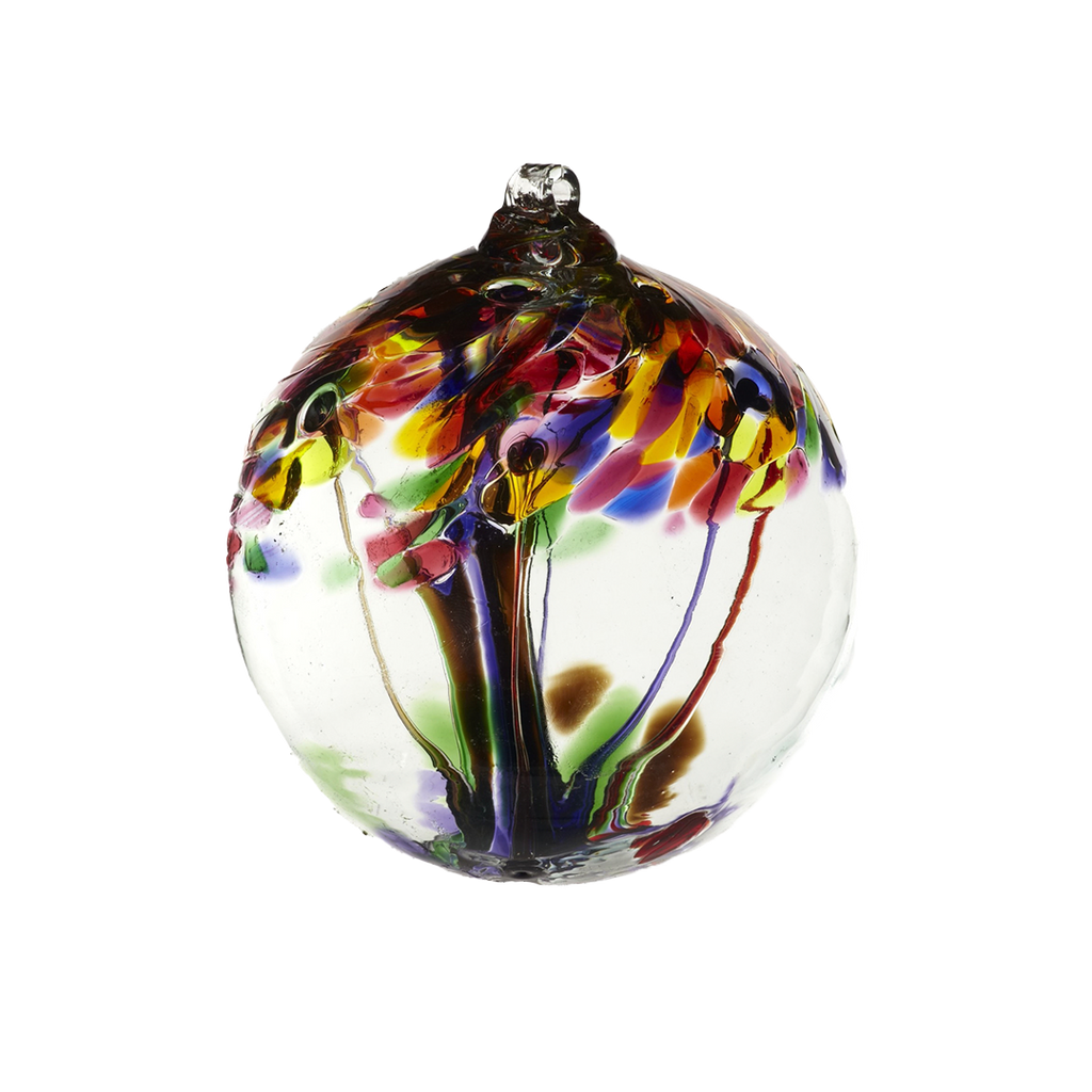 Clear glass orb with purple glass pulled through the middle and Yellow, Amber, Fuchsia, Purple, Brown and Green bits on top on a transparent background.