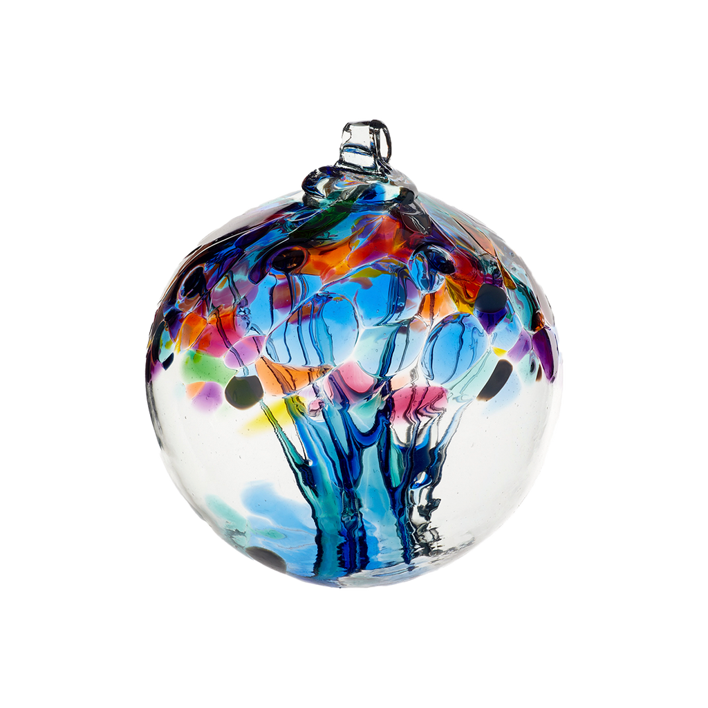 Clear glass orb with blue glass pulled through the middle and yellow, red, purple, pink, orange, green and blue bits on top on a transparent background.