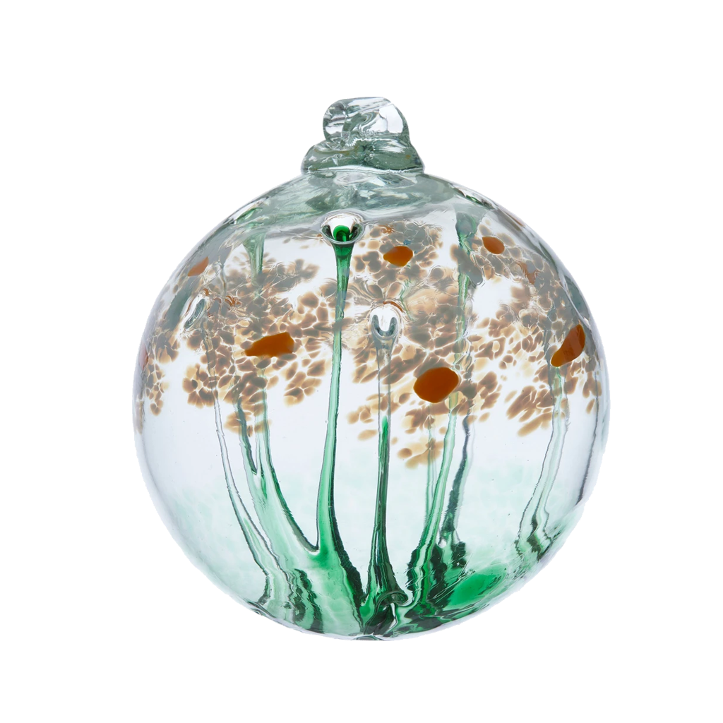 Clear glass orb with a green stem pulled from bottom to top to a canopy of white opaque glass blossoms and orange centres on a transparent background.